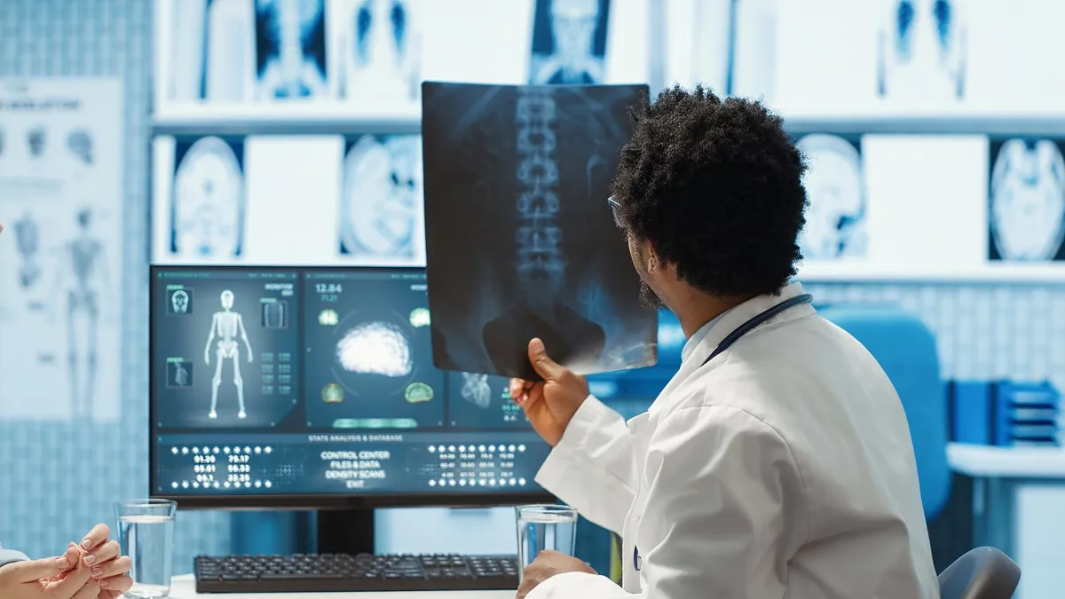 Physician reviewing abdominal diagnostic images to plan a nephrectomy in Medellín